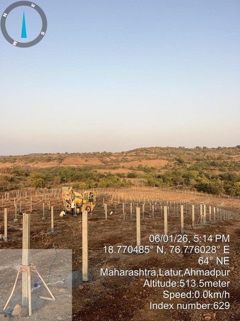 Rows of pile foundations across a solar site
